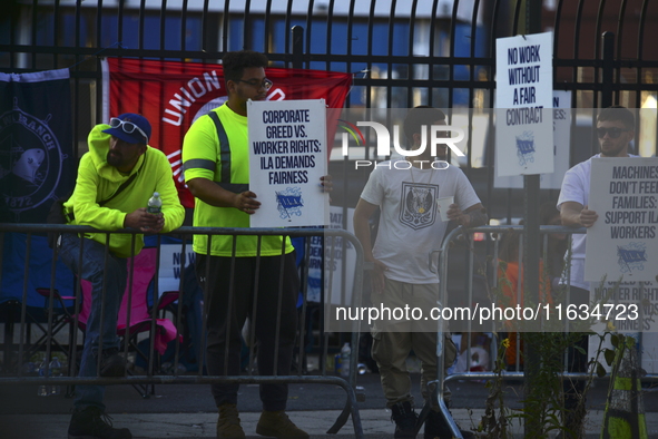 Longshoremen carry placards and demonstrate in front of the Red Hook terminal in Brooklyn, New York, U.S., on October 3, 2024. Longshoremen...