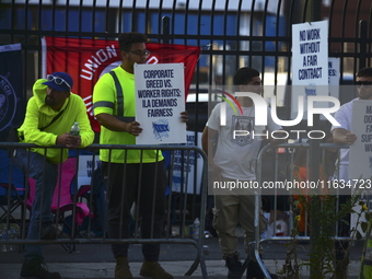 Longshoremen carry placards and demonstrate in front of the Red Hook terminal in Brooklyn, New York, U.S., on October 3, 2024. Longshoremen...