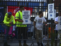 Longshoremen carry placards and demonstrate in front of the Red Hook terminal in Brooklyn, New York, U.S., on October 3, 2024. Longshoremen...