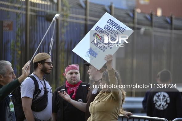 Longshoremen carry placards and demonstrate in front of the Red Hook terminal in Brooklyn, New York, U.S., on October 3, 2024. Longshoremen...