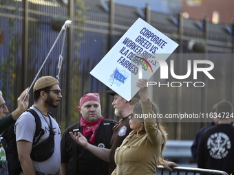 Longshoremen carry placards and demonstrate in front of the Red Hook terminal in Brooklyn, New York, U.S., on October 3, 2024. Longshoremen...