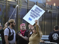 Longshoremen carry placards and demonstrate in front of the Red Hook terminal in Brooklyn, New York, U.S., on October 3, 2024. Longshoremen...