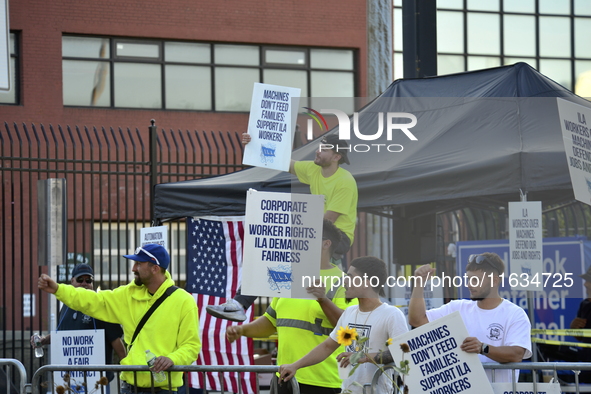 Longshoremen carry placards and demonstrate in front of the Red Hook terminal in Brooklyn, New York, U.S., on October 3, 2024. Longshoremen...