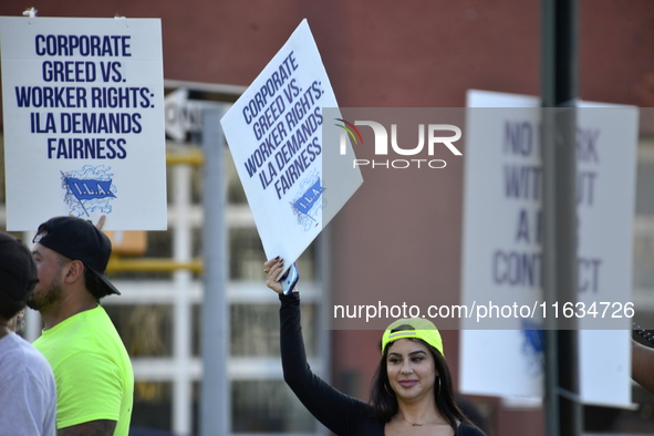 Longshoremen carry placards and demonstrate in front of the Red Hook terminal in Brooklyn, New York, U.S., on October 3, 2024. Longshoremen...