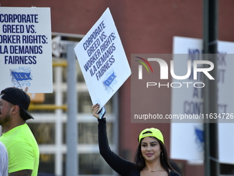 Longshoremen carry placards and demonstrate in front of the Red Hook terminal in Brooklyn, New York, U.S., on October 3, 2024. Longshoremen...