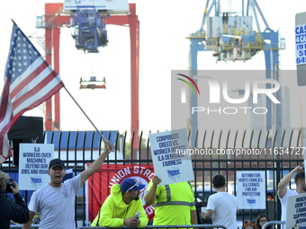 Longshoremen carry placards and demonstrate in front of the Red Hook terminal in Brooklyn, New York, U.S., on October 3, 2024. Longshoremen...