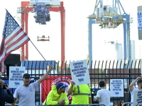 Longshoremen carry placards and demonstrate in front of the Red Hook terminal in Brooklyn, New York, U.S., on October 3, 2024. Longshoremen...