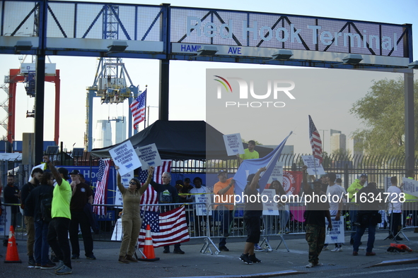 Longshoremen carry placards and demonstrate in front of the Red Hook terminal in Brooklyn, New York, U.S., on October 3, 2024. Longshoremen...