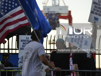 Longshoremen carry placards and demonstrate in front of the Red Hook terminal in Brooklyn, New York, U.S., on October 3, 2024. Longshoremen...