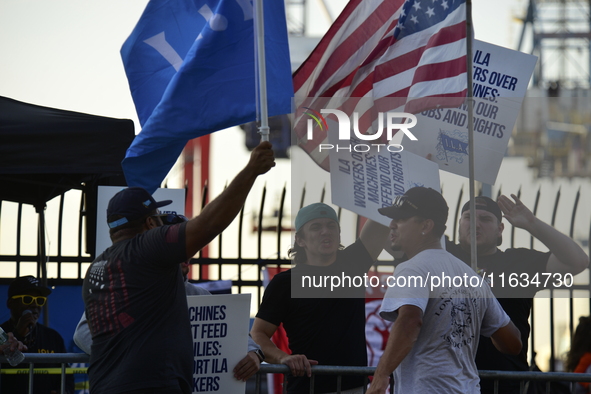 Longshoremen carry placards and demonstrate in front of the Red Hook terminal in Brooklyn, New York, U.S., on October 3, 2024. Longshoremen...