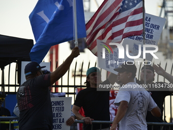 Longshoremen carry placards and demonstrate in front of the Red Hook terminal in Brooklyn, New York, U.S., on October 3, 2024. Longshoremen...