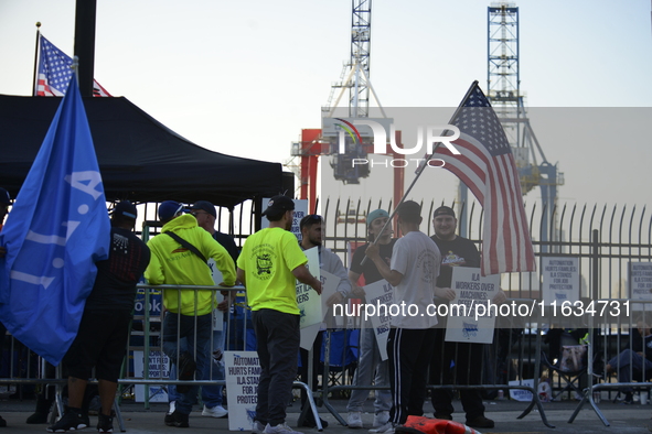 Longshoremen carry placards and demonstrate in front of the Red Hook terminal in Brooklyn, New York, U.S., on October 3, 2024. Longshoremen...