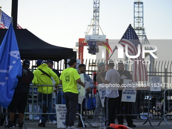 Longshoremen carry placards and demonstrate in front of the Red Hook terminal in Brooklyn, New York, U.S., on October 3, 2024. Longshoremen...