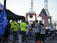 Longshoremen carry placards and demonstrate in front of the Red Hook terminal in Brooklyn, New York, U.S., on October 3, 2024. Longshoremen...