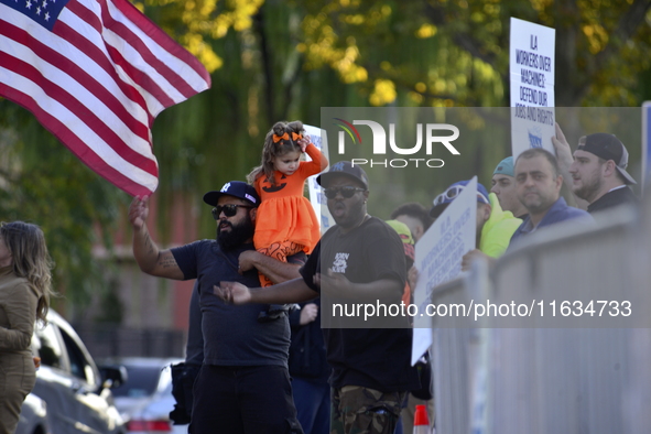 Longshoremen carry placards and demonstrate in front of the Red Hook terminal in Brooklyn, New York, U.S., on October 3, 2024. Longshoremen...