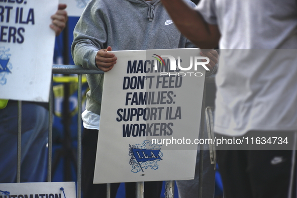 Longshoremen carry placards and demonstrate in front of the Red Hook terminal in Brooklyn, New York, U.S., on October 3, 2024. Longshoremen...