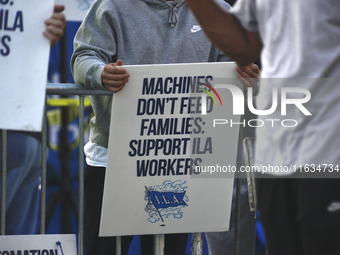 Longshoremen carry placards and demonstrate in front of the Red Hook terminal in Brooklyn, New York, U.S., on October 3, 2024. Longshoremen...