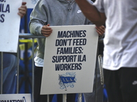 Longshoremen carry placards and demonstrate in front of the Red Hook terminal in Brooklyn, New York, U.S., on October 3, 2024. Longshoremen...