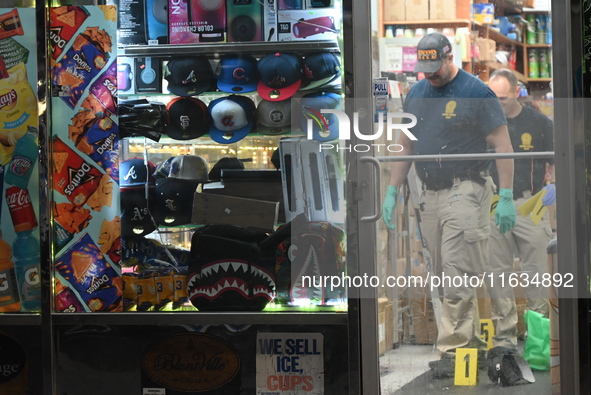 Crime scene investigators from the NYPD place evidence markers and search for clues at the scene where a 29-year-old woman is fatally stabbe...