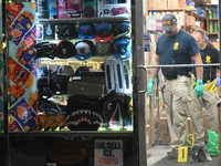 Crime scene investigators from the NYPD place evidence markers and search for clues at the scene where a 29-year-old woman is fatally stabbe...