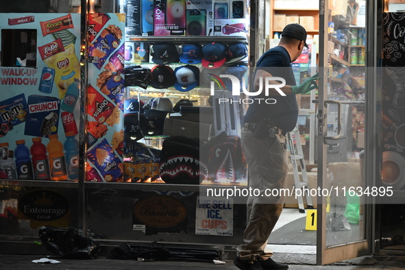 Crime scene investigators from the NYPD place evidence markers and search for clues at the scene where a 29-year-old woman is fatally stabbe...