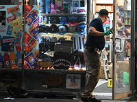 Crime scene investigators from the NYPD place evidence markers and search for clues at the scene where a 29-year-old woman is fatally stabbe...