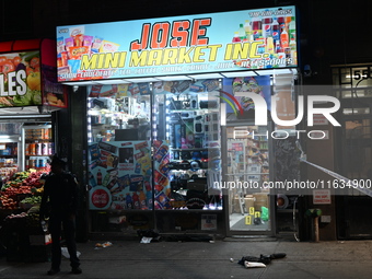 Crime scene investigators from the NYPD place evidence markers and search for clues at the scene where a 29-year-old woman is fatally stabbe...