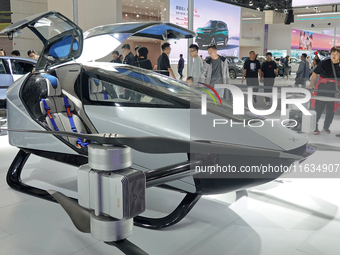 Visitors look at the XPENG AEROHT ''Traveler X2'' electric flying aircraft at the 2024 China (Tianjin) International Auto Show in Tianjin, C...