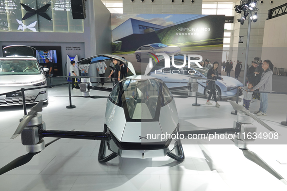 Visitors look at the XPENG AEROHT ''Traveler X2'' electric flying aircraft at the 2024 China (Tianjin) International Auto Show in Tianjin, C...