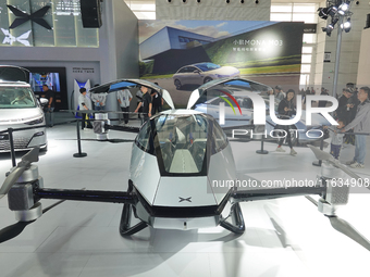 Visitors look at the XPENG AEROHT ''Traveler X2'' electric flying aircraft at the 2024 China (Tianjin) International Auto Show in Tianjin, C...