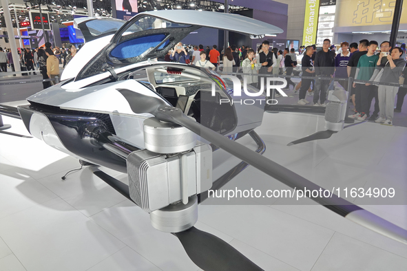 Visitors look at the XPENG AEROHT ''Traveler X2'' electric flying aircraft at the 2024 China (Tianjin) International Auto Show in Tianjin, C...