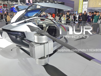 Visitors look at the XPENG AEROHT ''Traveler X2'' electric flying aircraft at the 2024 China (Tianjin) International Auto Show in Tianjin, C...