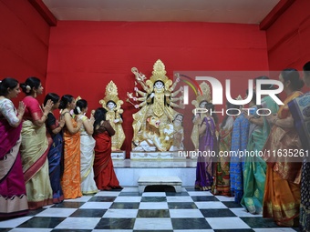 Women participate in the unveiling ceremony of the rare Mahishasur Mardini Durgati Nashini idol, alongside Lord Ganesha, Kartikeya, Goddess...