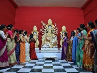 Women participate in the unveiling ceremony of the rare Mahishasur Mardini Durgati Nashini idol, alongside Lord Ganesha, Kartikeya, Goddess...