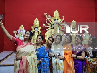 In Jaipur, Rajasthan, India, on October 3, 2024, women take a selfie as they participate in the unveiling ceremony of the rare Mahishasur Ma...