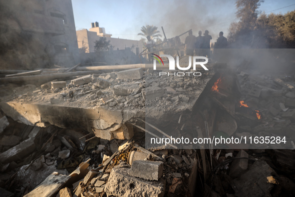 Palestinians inspect a house damaged in an Israeli airstrike in Deir al-Balah, central Gaza Strip, on October 4, 2024, amid the ongoing war...