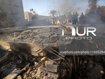 Palestinians inspect a house damaged in an Israeli airstrike in Deir al-Balah, central Gaza Strip, on October 4, 2024, amid the ongoing war...