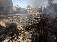 Palestinians inspect a house damaged in an Israeli airstrike in Deir al-Balah, central Gaza Strip, on October 4, 2024, amid the ongoing war...