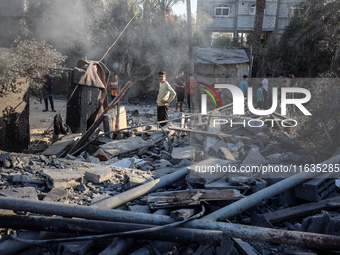 Palestinians inspect a house damaged in an Israeli airstrike in Deir al-Balah, central Gaza Strip, on October 4, 2024, amid the ongoing war...