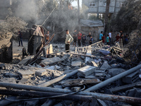 Palestinians inspect a house damaged in an Israeli airstrike in Deir al-Balah, central Gaza Strip, on October 4, 2024, amid the ongoing war...