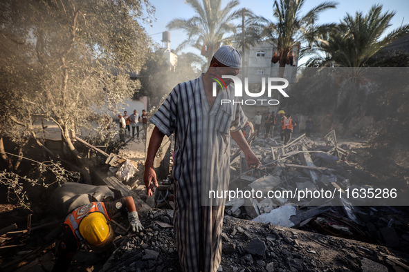 Palestinians inspect a house damaged in an Israeli airstrike in Deir al-Balah, central Gaza Strip, on October 4, 2024, amid the ongoing war...