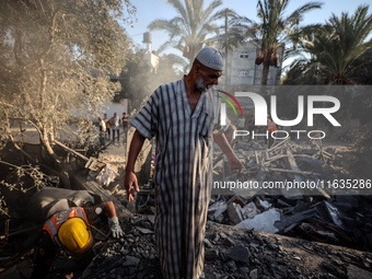 Palestinians inspect a house damaged in an Israeli airstrike in Deir al-Balah, central Gaza Strip, on October 4, 2024, amid the ongoing war...