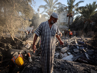 Palestinians inspect a house damaged in an Israeli airstrike in Deir al-Balah, central Gaza Strip, on October 4, 2024, amid the ongoing war...