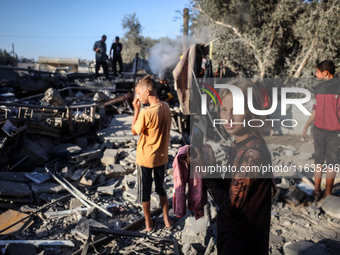 Palestinians inspect a house damaged in an Israeli airstrike in Deir al-Balah, central Gaza Strip, on October 4, 2024, amid the ongoing war...