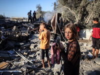 Palestinians inspect a house damaged in an Israeli airstrike in Deir al-Balah, central Gaza Strip, on October 4, 2024, amid the ongoing war...