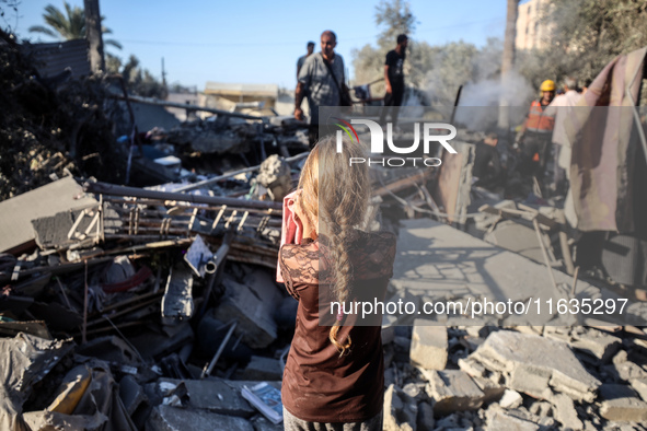 Palestinians inspect a house damaged in an Israeli airstrike in Deir al-Balah, central Gaza Strip, on October 4, 2024, amid the ongoing war...