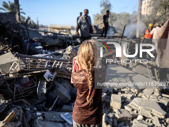 Palestinians inspect a house damaged in an Israeli airstrike in Deir al-Balah, central Gaza Strip, on October 4, 2024, amid the ongoing war...