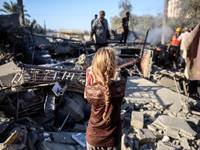 Palestinians inspect a house damaged in an Israeli airstrike in Deir al-Balah, central Gaza Strip, on October 4, 2024, amid the ongoing war...