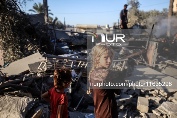 Palestinians inspect a house damaged in an Israeli airstrike in Deir al-Balah, central Gaza Strip, on October 4, 2024, amid the ongoing war...