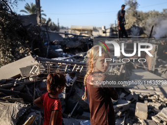 Palestinians inspect a house damaged in an Israeli airstrike in Deir al-Balah, central Gaza Strip, on October 4, 2024, amid the ongoing war...